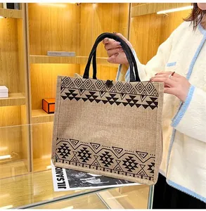 Ethnic style burlap tote bag featuring geometric patterns and durable black handles