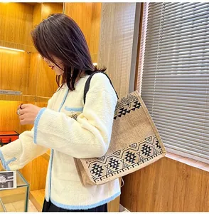Detailed side view of ethnic pattern tote bag on model shoulder with rustic burlap texture