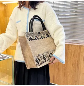 Macro detail of ethnic jute tote bag featuring geometric patterns and woven handles