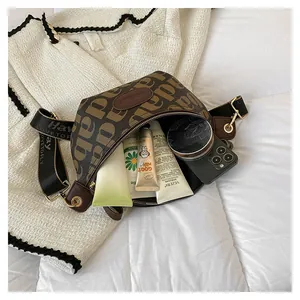 Detail showing high-capacity brown letter-print chest bag with daily cosmetics and phone
