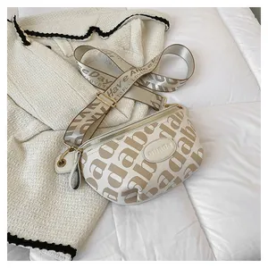 Detail of crossbody bag with letter print strap and embossed logo on tweed background