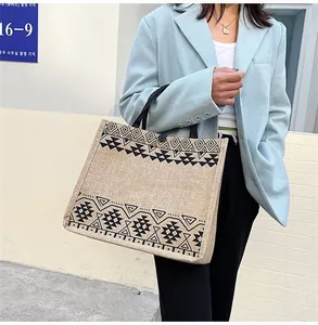 Ethnic large linen tote bag with geometric patterns shown in an outdoor lifestyle setting