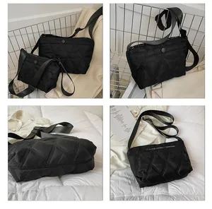 Detail view of black quilted nylon crossbody bag with adjustable strap and diamond texture