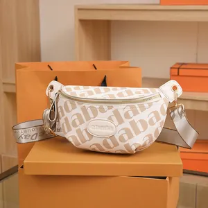 Fashionable cream monogram waist bag with wide strap and gold hardware accents