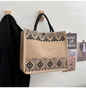 Close-up of ethnic geometric pattern on large linen tote bag with black round handles