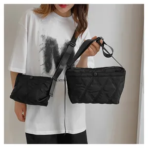 Detail of black quilted crossbody bag set featuring Forever Young text and rhombic pattern