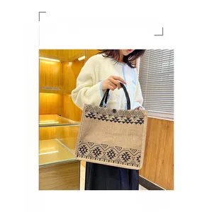 Detail of ethnic geometric pattern jute tote bag with button closure and handle