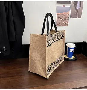 Detail view of ethnic jute tote bag with geometric prints and thick black rope handles