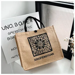 Detail of jute tote bag showing mandala print, woven cotton handles and button closure