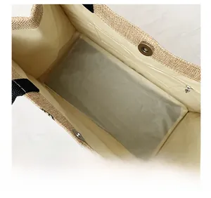 Detail shot of spacious jute tote interior featuring a magnetic closure and zippered pocket