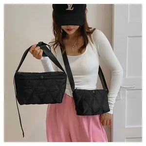 Detail of black quilted dumpling bags in two sizes with elegant diamond pattern finish