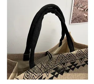 Detail showing woven jute texture, black geometric patterns and braided rope handles