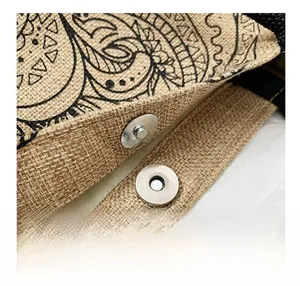 Detail of the magnetic buckle closure on a jute tote bag with floral print