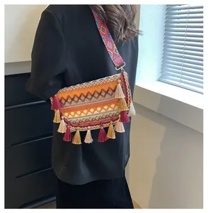 Close-up of Bohemian crossbody bag with colorful knit wave patterns and tassel details