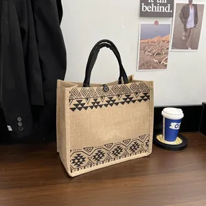 Detail of jute tote bag showing ethnic geometric prints and black button closure