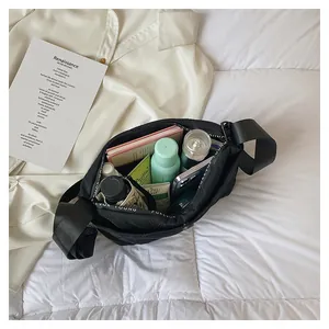 Spacious black nylon crescent bag interior showing high capacity storage for daily essentials