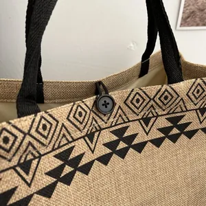 Close-up of jute tote bag with geometric tribal print and button loop closure detail