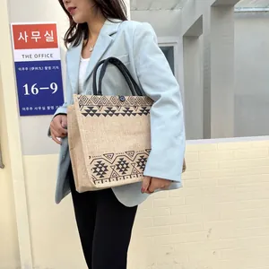 Ethnic jute tote bag with geometric patterns and round woven handles for daily use