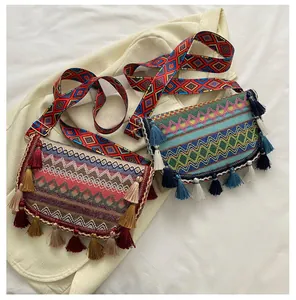 Detailed close-up of bohemian woven crossbody bags with colorful tassels and patterned straps