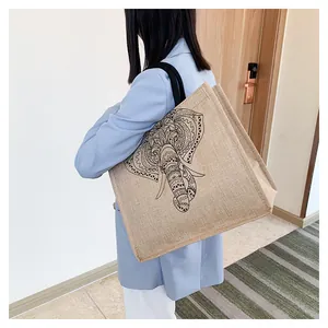 Detailed texture of jute tote bag with mandala elephant print worn over the shoulder