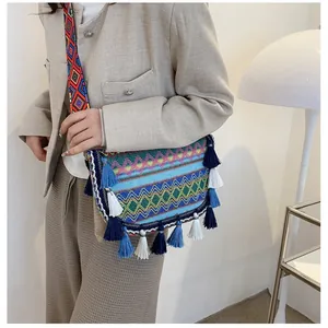 Ethnic bohemian crossbody bag with colorful embroidery and decorative tassels for women
