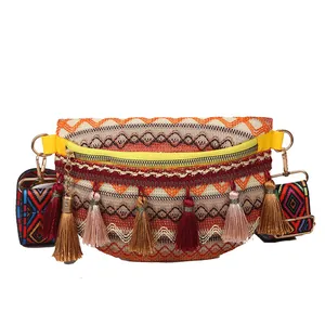 Bohemian woven crossbody waist bag with colorful tassels and geometric patterned strap