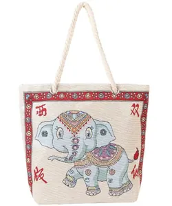 Detailed view of canvas tote bag with embroidered elephant and braided rope handle