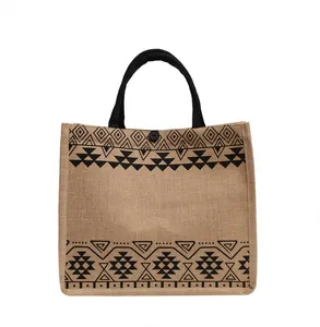 Close-up of ethnic geometric pattern and button closure on jute tote bag