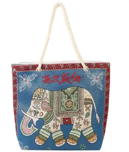 Detail view of ethnic blue tote bag with elephant pattern and braided rope handles
