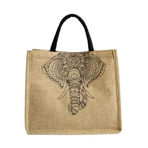 Vintage jute tote bag with black elephant mandala print and woven handles on white background