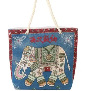 Ethnic blue canvas tote bag featuring elephant embroidery and rustic rope handles