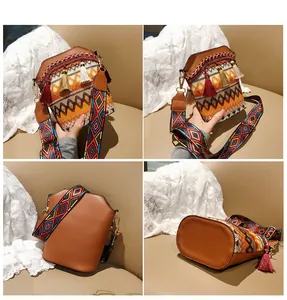 Dettagli della borsa a secchiello boho con ricami, frange e tracolla larga colorata