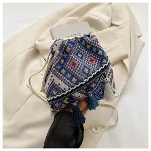 Close-up of bohemian bucket bag with geometric diamond patterns and tassel drawstring