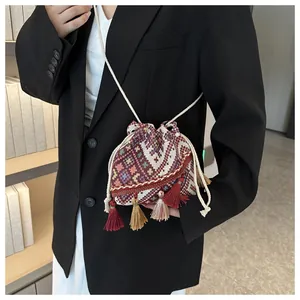 Detailed shot of ethnic diamond pattern bucket bag with multi-color tassels and drawstring