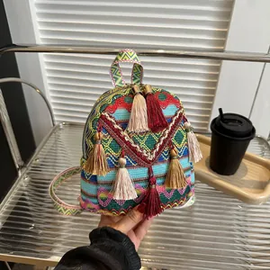 Mini bohemian woven backpack with colorful geometric patterns and decorative tassels