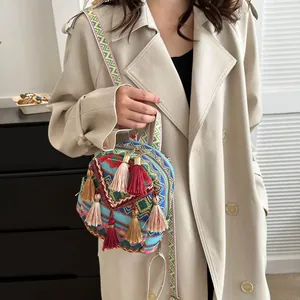 Ethnic bohemian woven mini backpack with vibrant geometric patterns and decorative tassels
