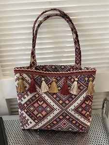 Ethnic woven tote bag with colorful geometric patterns and decorative tassels