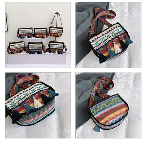 Close-up of woven ethnic crossbody bag with colorful tassels and patterned wide strap