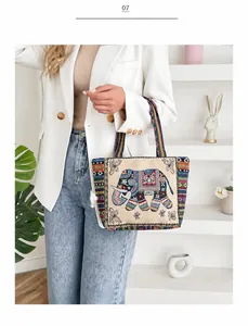 Detail of bohemian ethnic tote bag with colorful elephant embroidery and gold thread