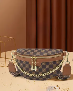 Detail of checkered crescent bag with gold chain and vintage print wide strap