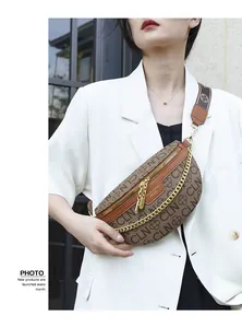 Detail of vintage brown monogram crescent bag with gold chain and woven strap