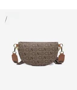 Rear view of a brown patterned crescent crossbody bag with a wide fabric shoulder strap