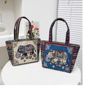 Detailed embroidery of elephant pattern on ethnic style woven fabric shoulder bag