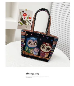 Close-up of ethnic style knit bag with owl embroidery and colorful striped straps