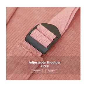 Detailed close-up of adjustable shoulder strap on a pink corduroy backpack