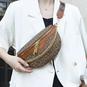 Brown monogram crescent crossbody bag with gold chain and wide patterned shoulder strap