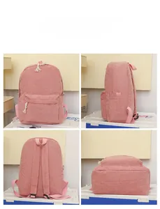 Pink corduroy backpack with sturdy rope zipper pulls and front pocket in detail view