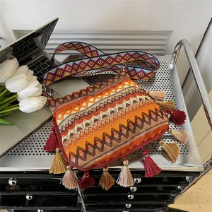 Bohemian woven crossbody bag with colorful geometric patterns and fringe tassels