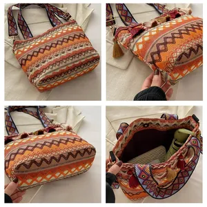 Detail view of large Bohemian woven bag with ethnic strap, tassel decor and spacious interior