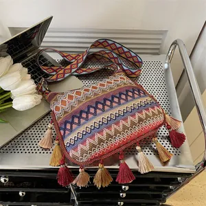 Ethnic bohemian crossbody bag with colorful geometric patterns and long decorative tassels
